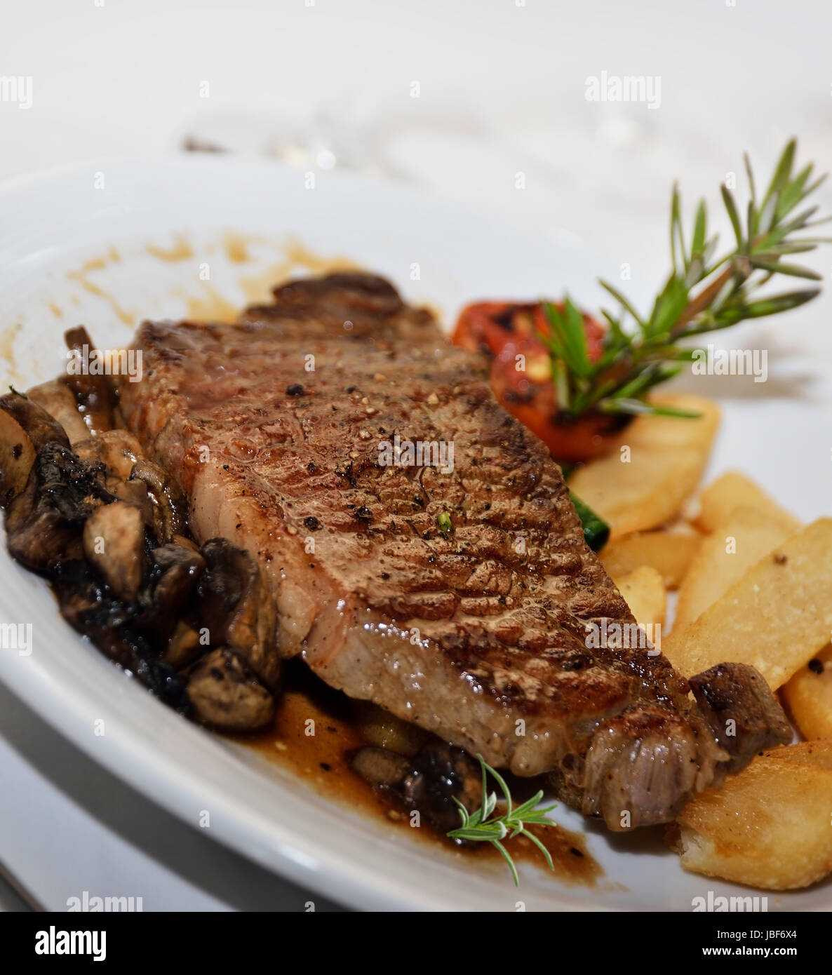 Grilled Steak With Mushrooms And Potatoes Stock Photo - Alamy