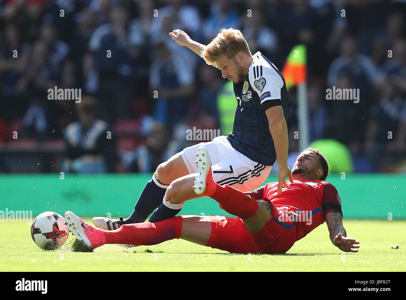 England's Jake Livermore (right) and Scotland's Stuart Armstrong battle for the ball during the 2018 FIFA World Cup qualifying, Group F match at Hampden Park, Glasgow. Stock Photo