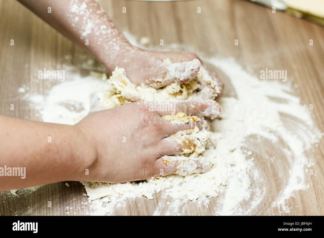 Closeup of woman hands kneading dough on the kitchen table Stock Photo ...