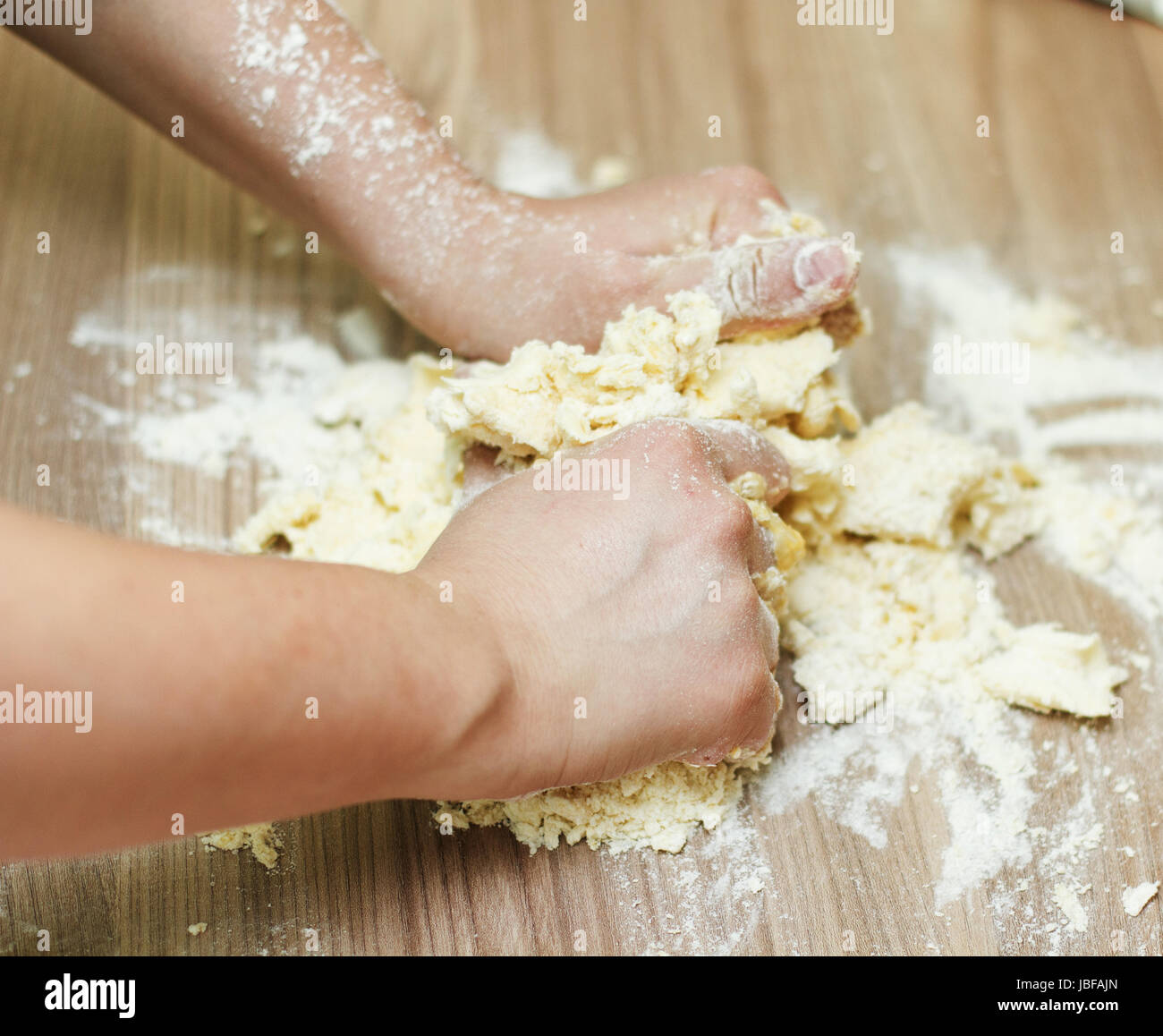 Closeup of woman hands kneading dough on the kitchen table Stock Photo ...