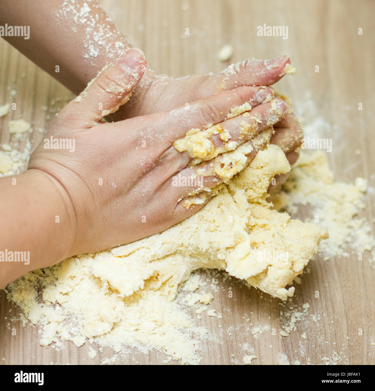Closeup of woman hands kneading dough on the kitchen table Stock Photo ...