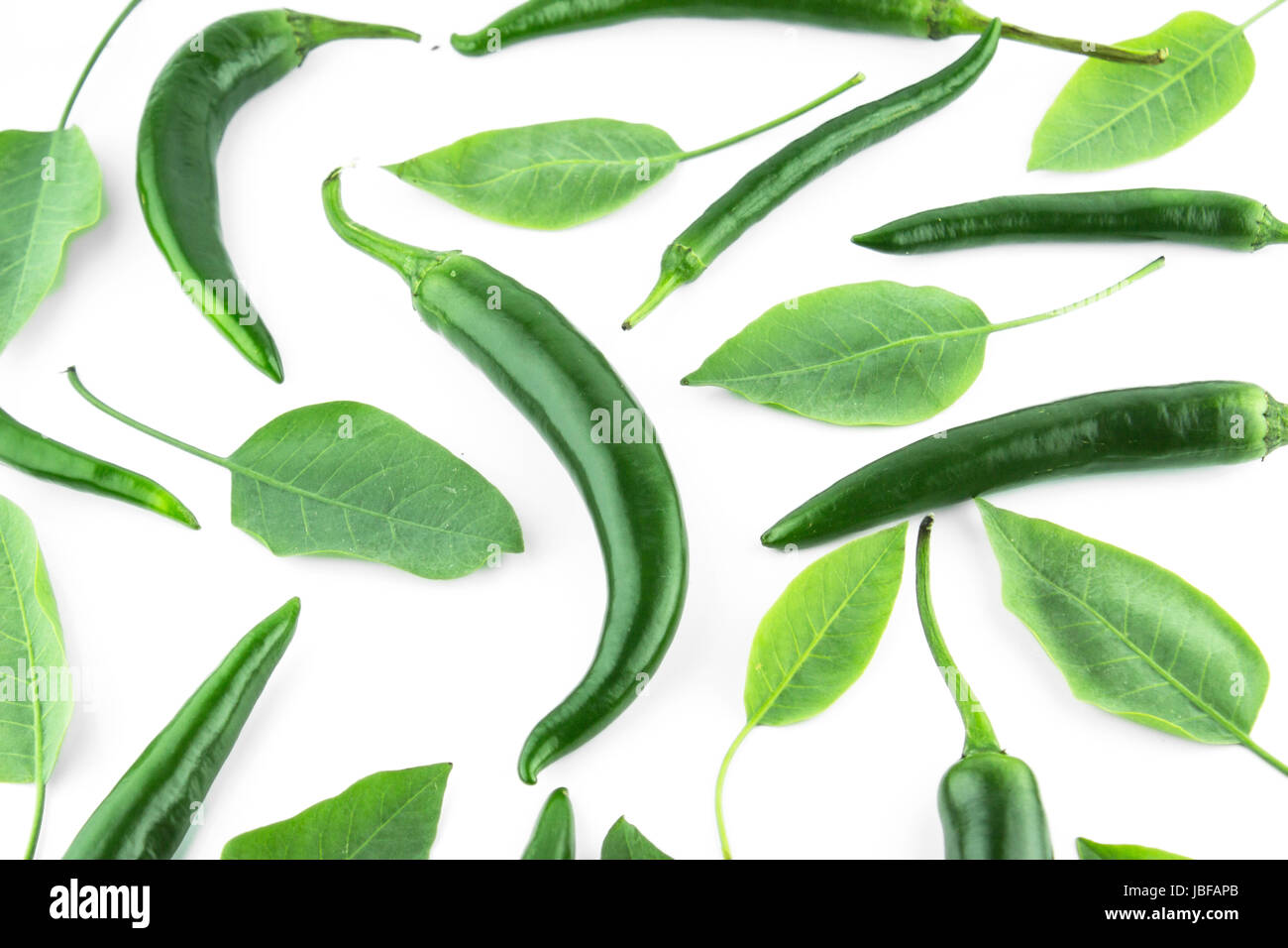 green hot chili pepper with leaves on a white background Stock Photo