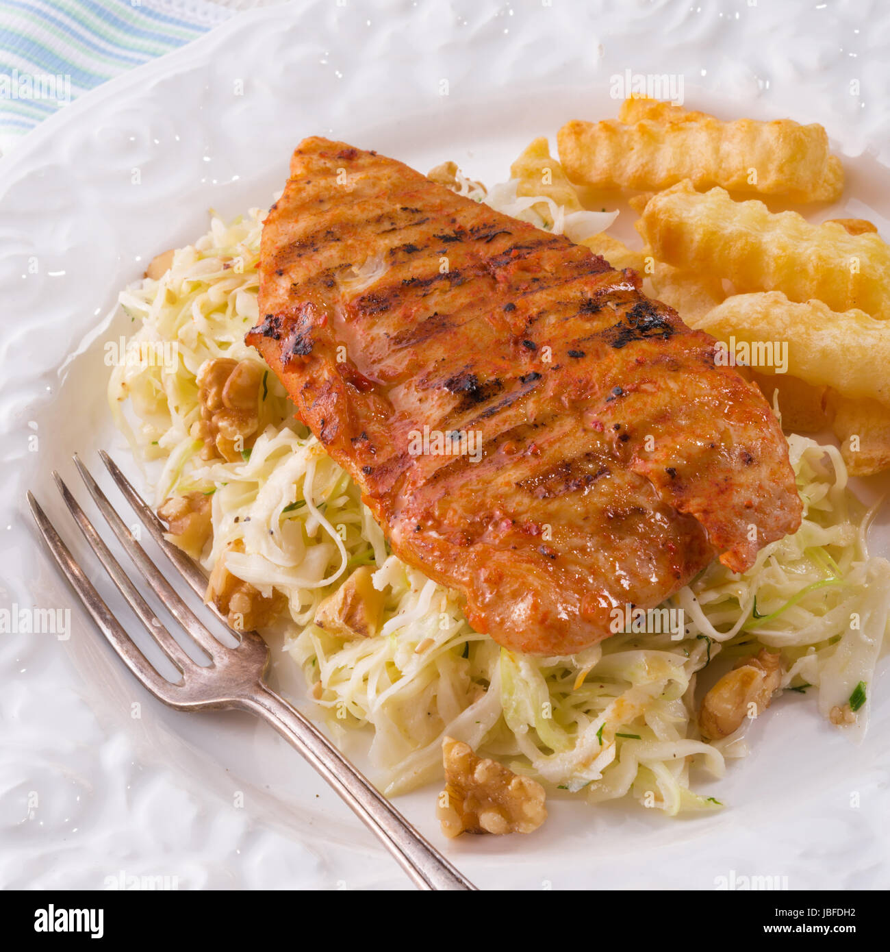 grilled chicken, cabbage salad with nuts and chips Stock Photo