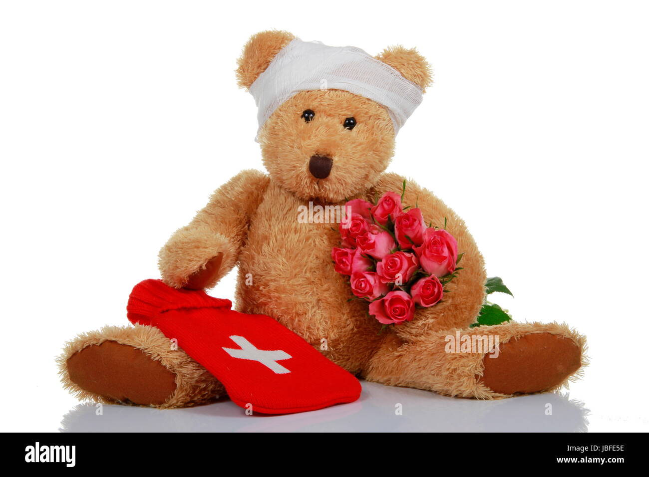 teddy bear with roses and hot water bottle Stock Photo