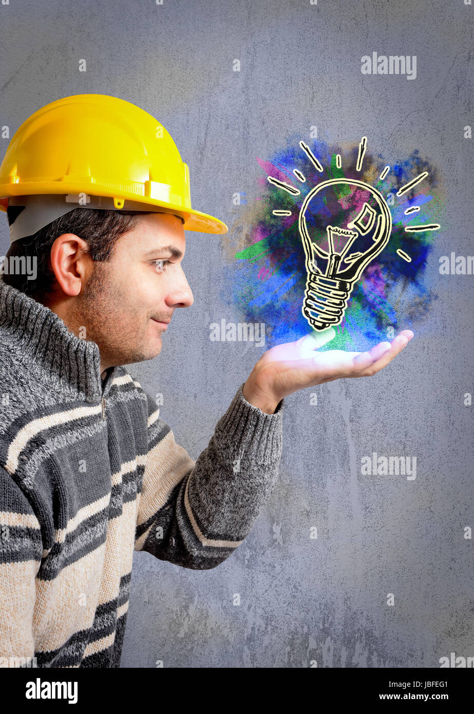 engineer with a helmet on his head, looking a building project that grows on his hand Stock Photo