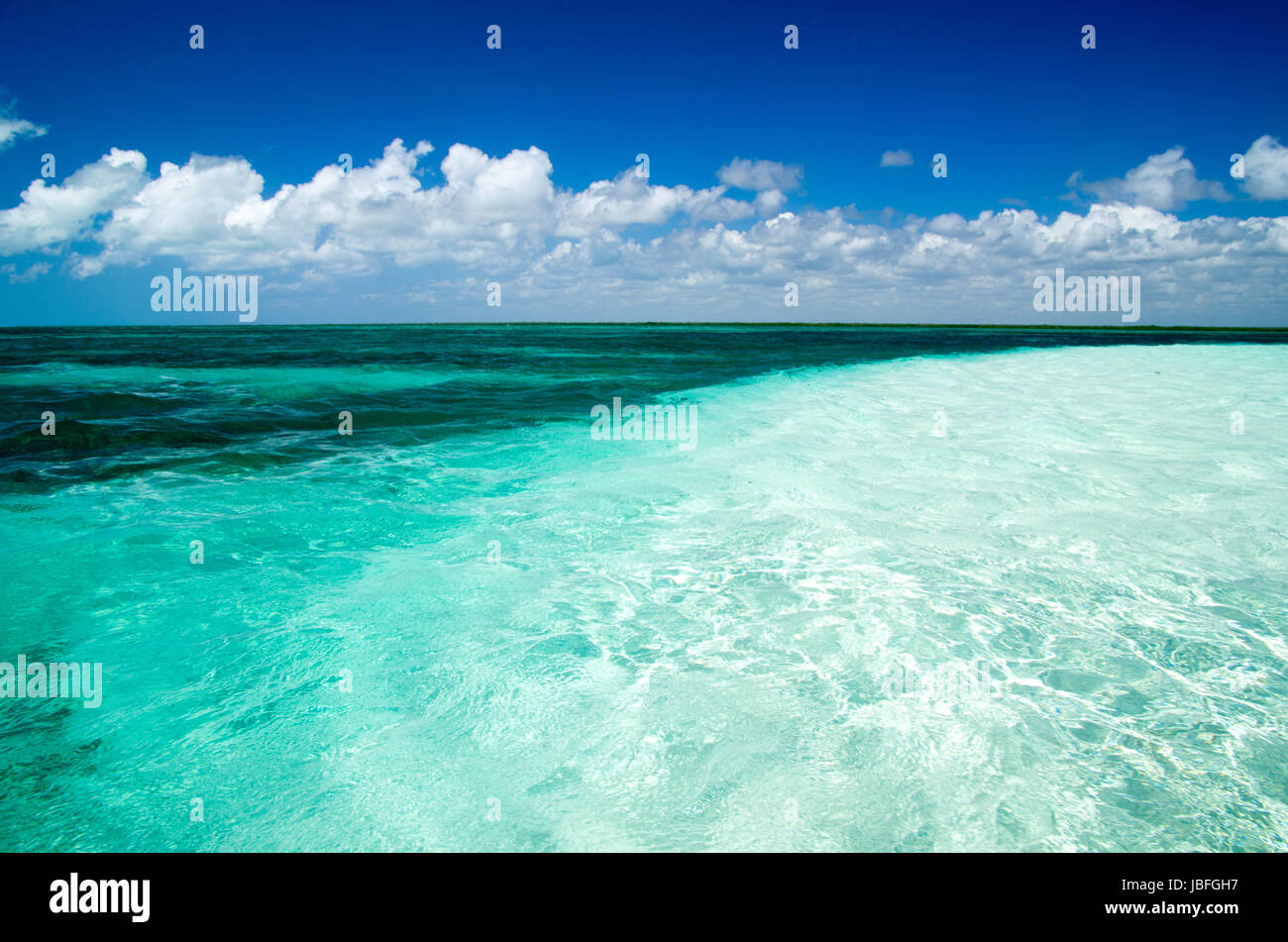 Blue sea under clouds sky Stock Photo - Alamy
