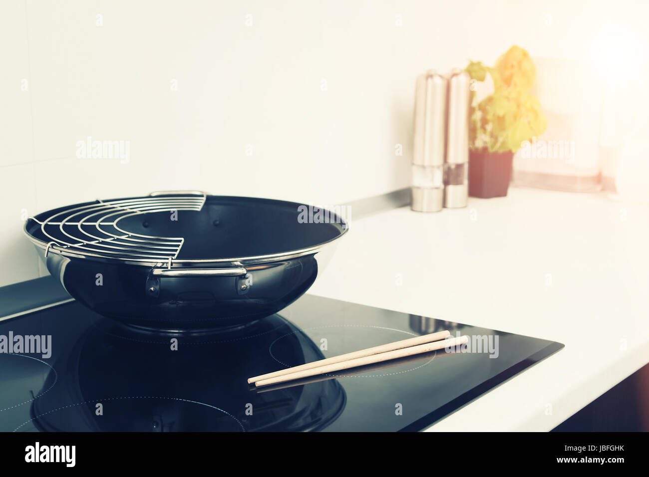 Frying pan in modern kitchen with induction stove Stock Photo Alamy