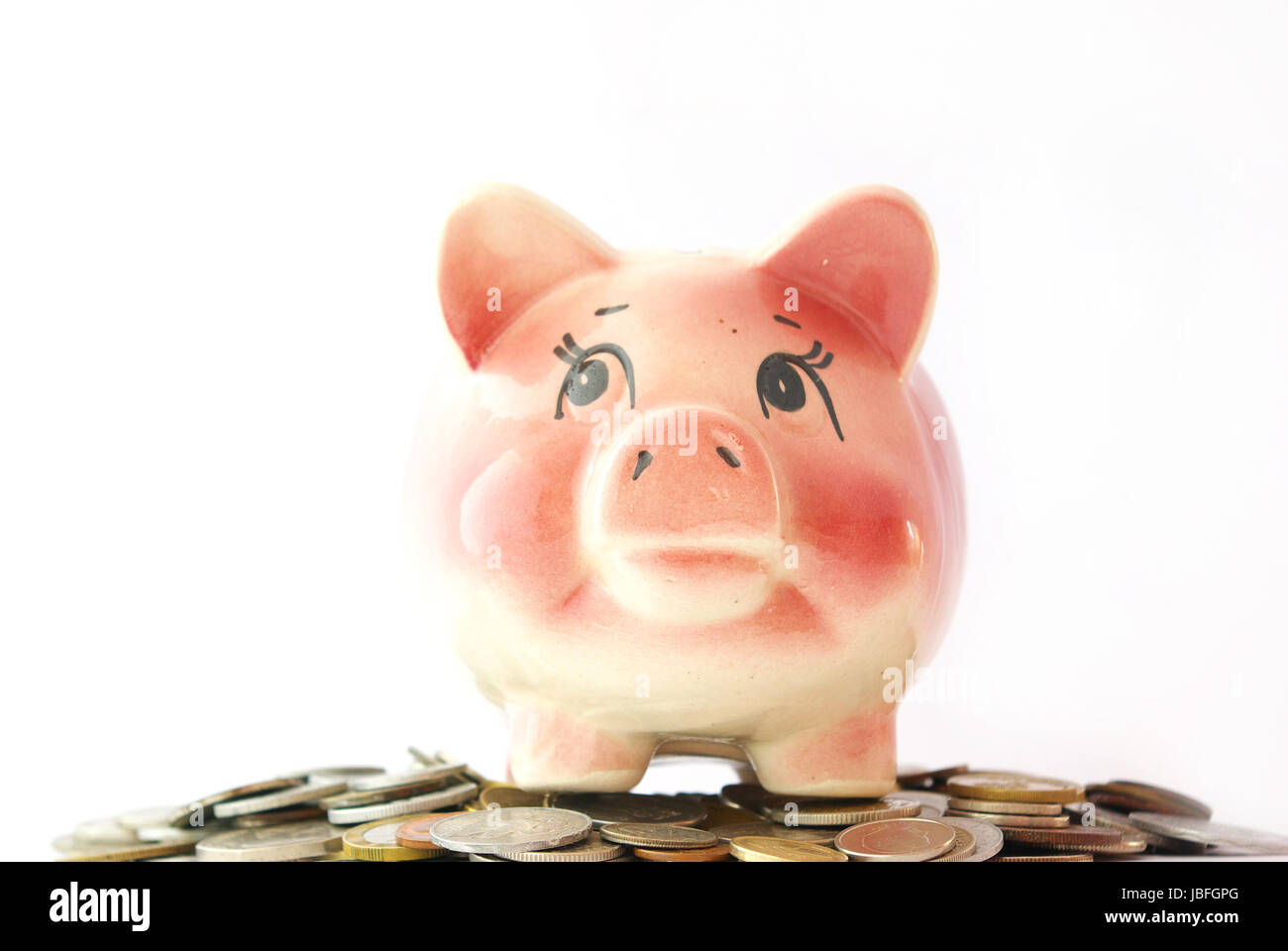 Pink piggy bank isolated on white background with coins Stock Photo - Alamy