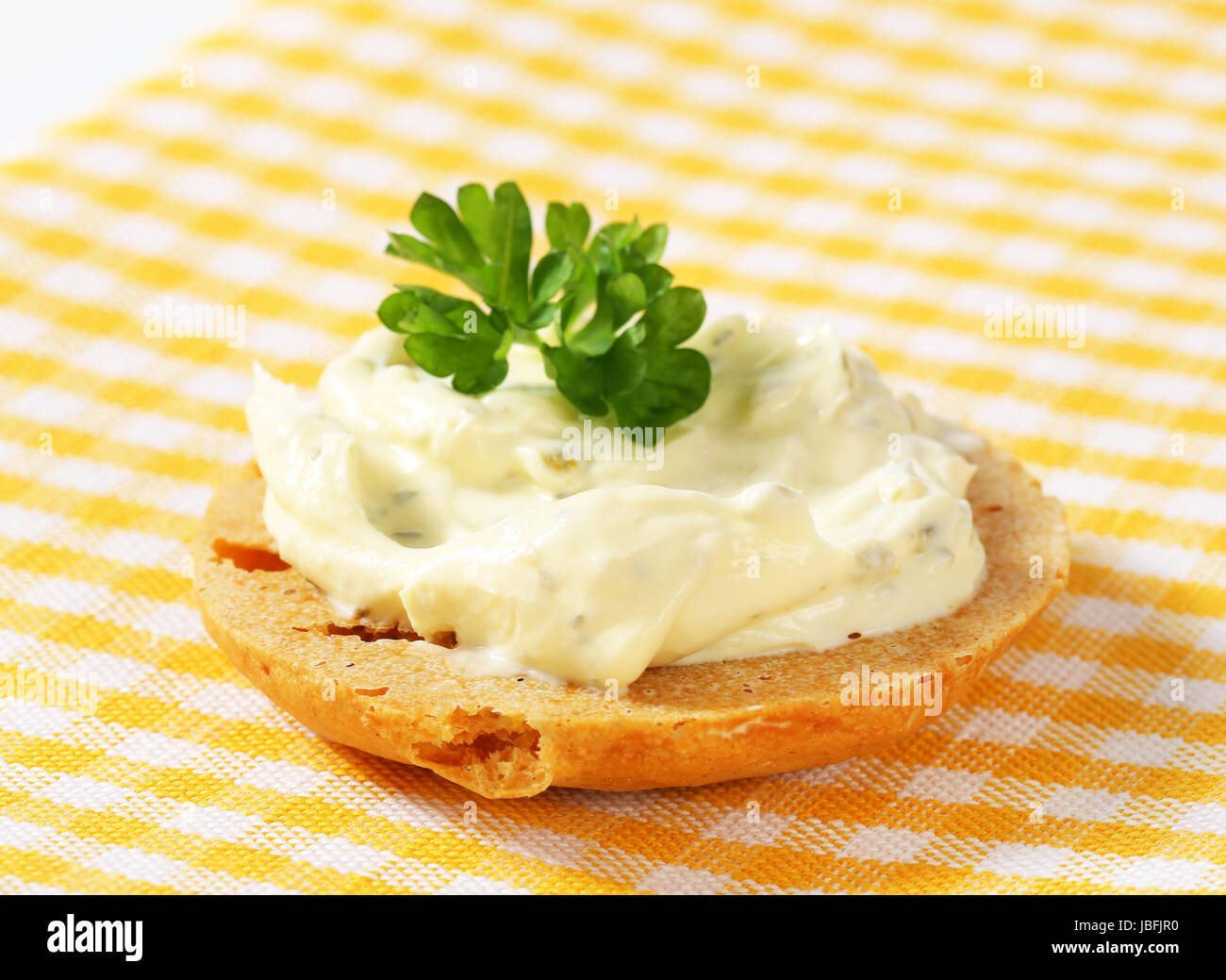 Round cracker with cream cheese spread Stock Photo Alamy