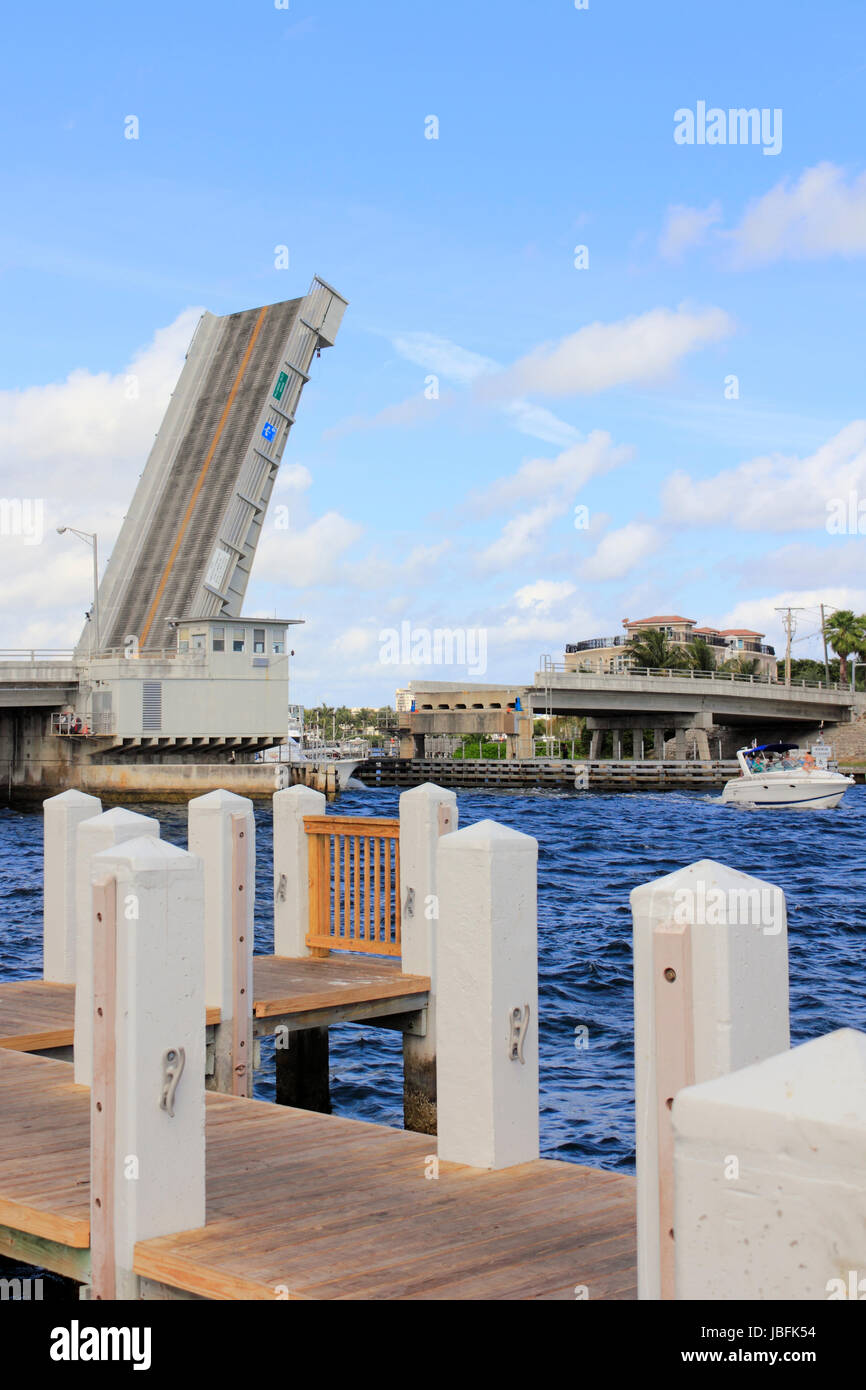 POMPANO BEACH, FLORIDA - FEBRUARY 12, 2014: Raised up Hillsboro Inlet Draw Bridge in Hillsboro Mile with a boat that just passed under it coming from the Intracoastal Waterway to the Atlantic Ocean. Stock Photo