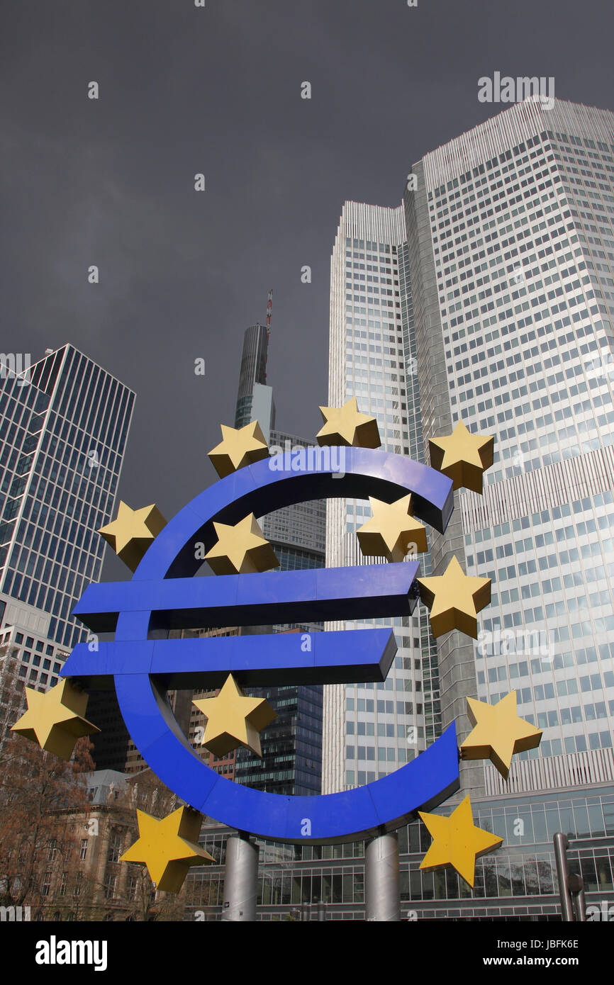 euro symbol and banks under dark skies Stock Photo