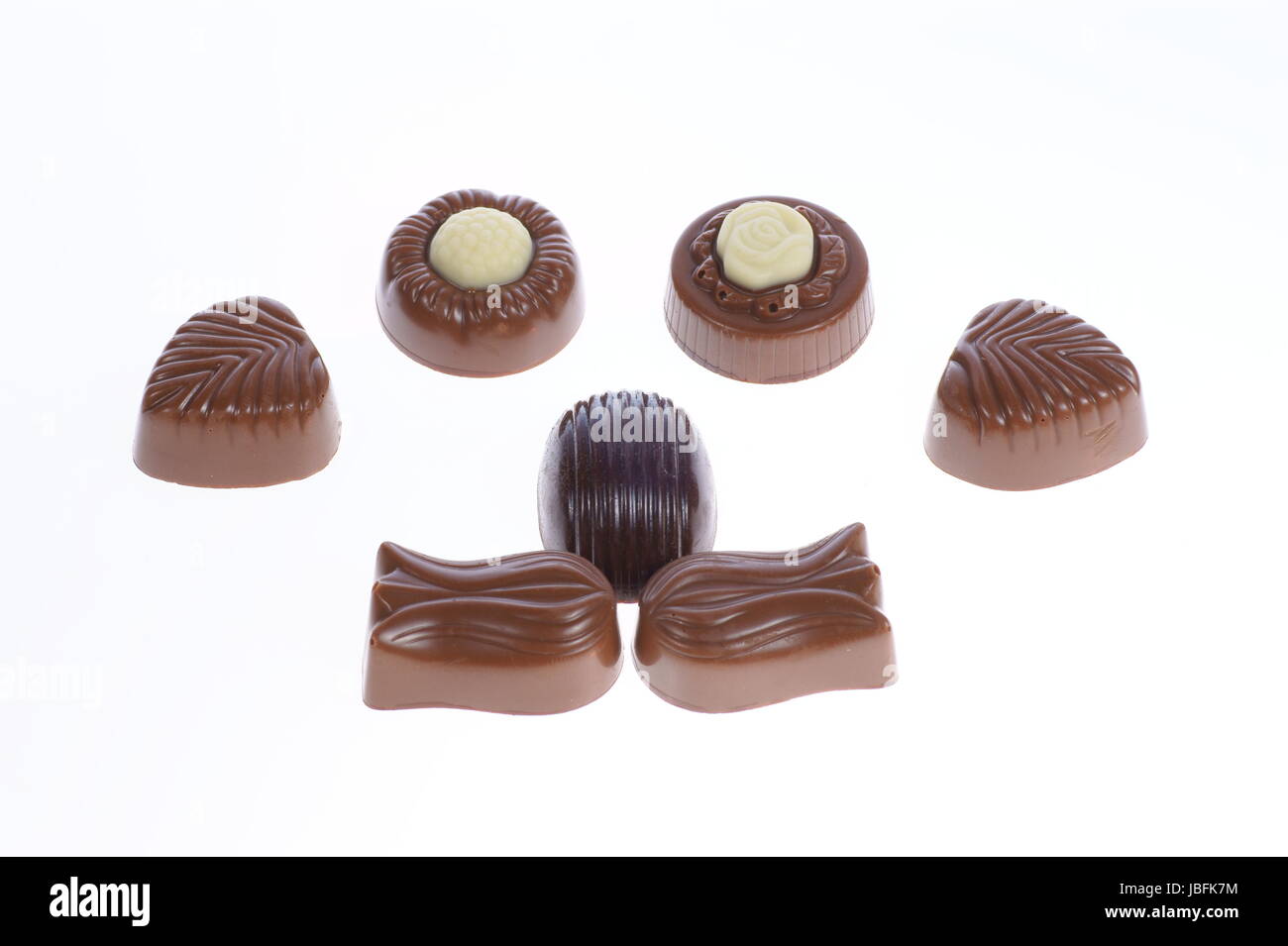 chocolate pralines on white background. Delicious dark and milk