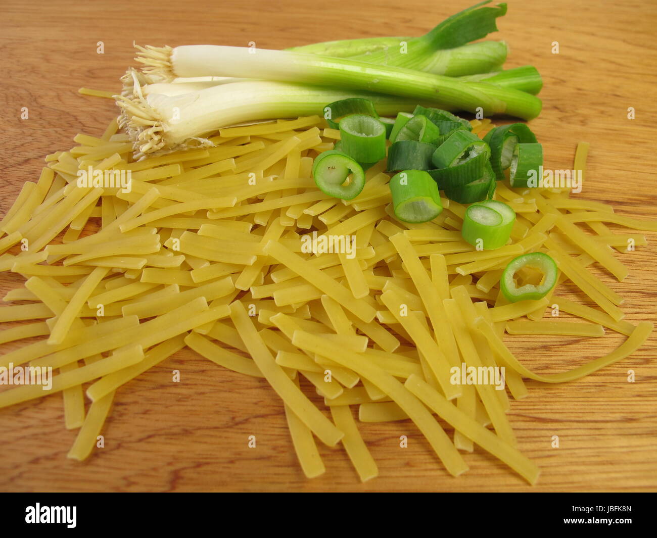 narrow ribbon noodles and spring onions Stock Photo