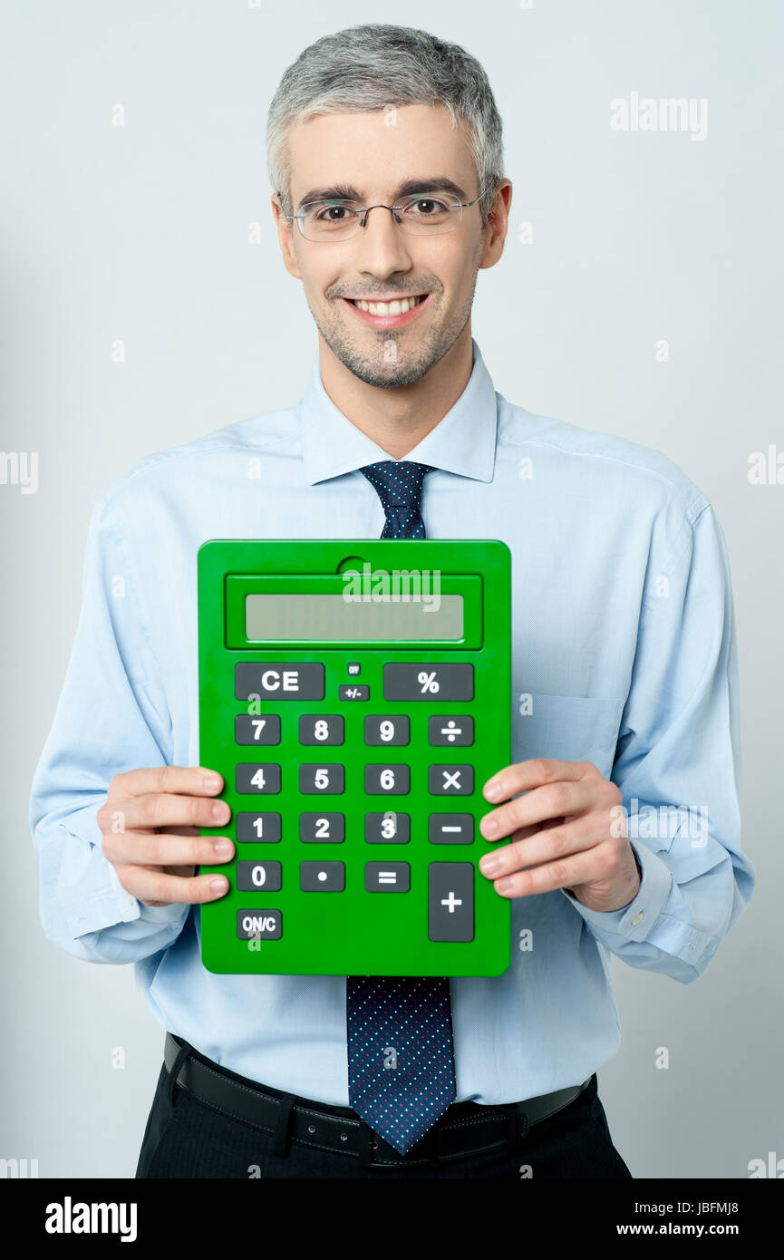 Smiling corporate man showing big green calculator Stock Photo - Alamy