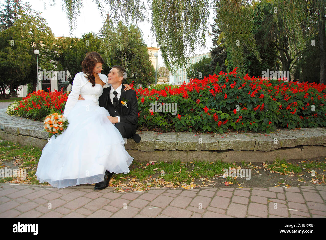 Bride and Groom in the park with the bridal bouquet Stock Photo - Alamy