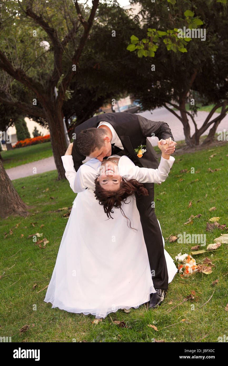 Bride and Groom in the park with the bridal bouquet Stock Photo - Alamy