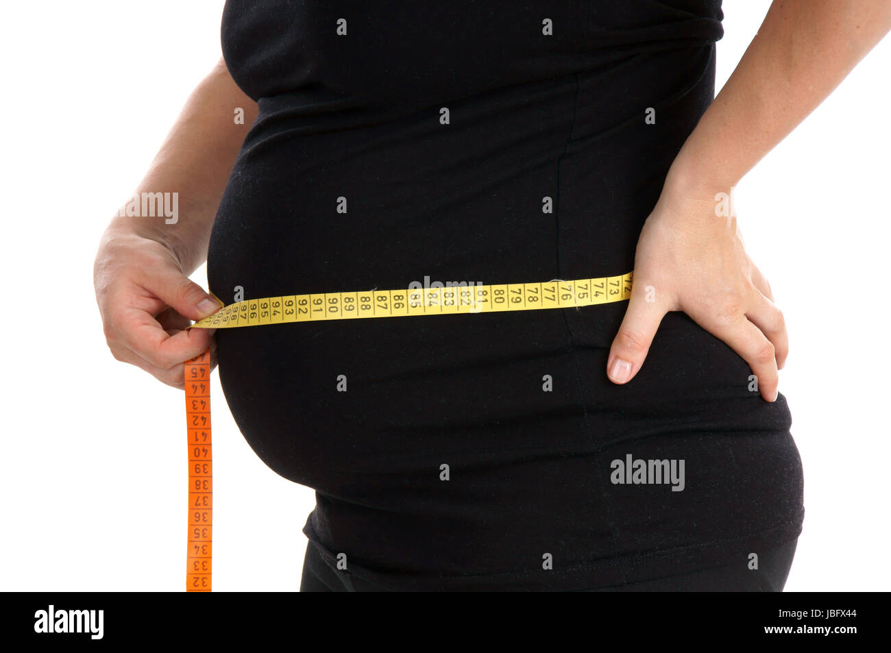 Pregnant woman measuring her waist Stock Photo