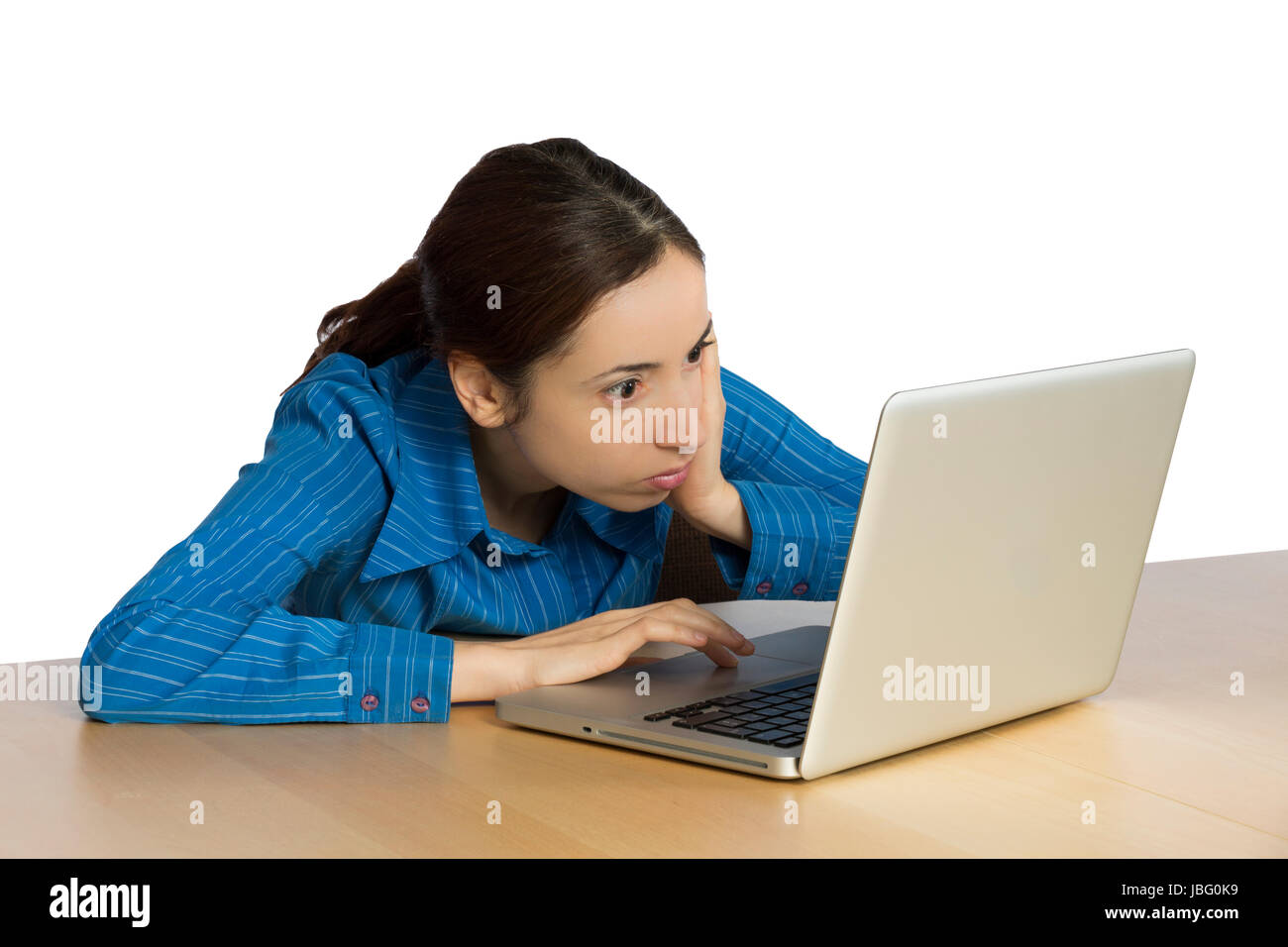 Young business woman is looking with a shocked expression to her comouter. Stock Photo