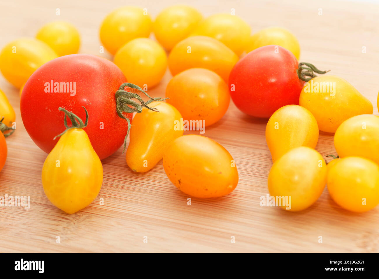 many tomatoes on wood Stock Photo