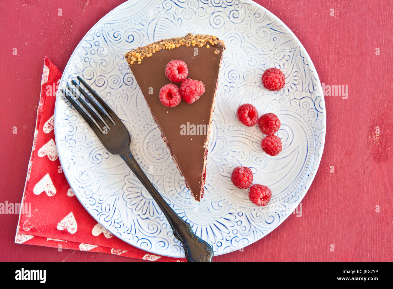 Ein Stueck Torte mit roten Fruechten und Schokolade Stock Photo