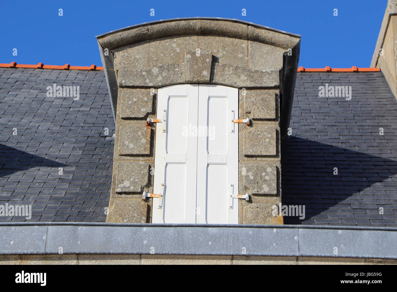 Dormer window with closed shutter Stock Photo