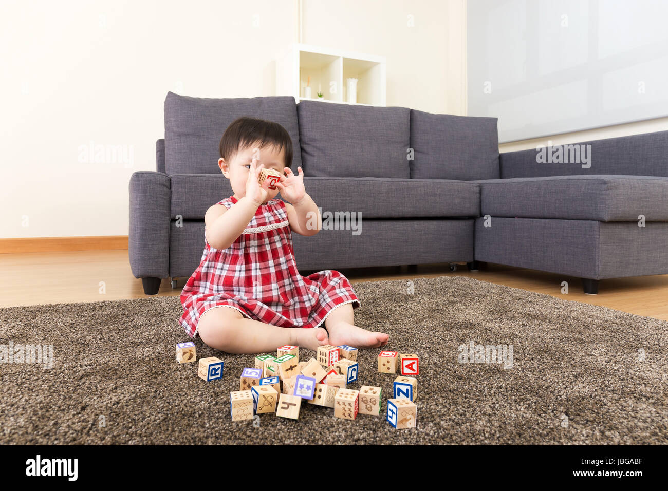 Asian little girl playing toy block at home Stock Photo - Alamy