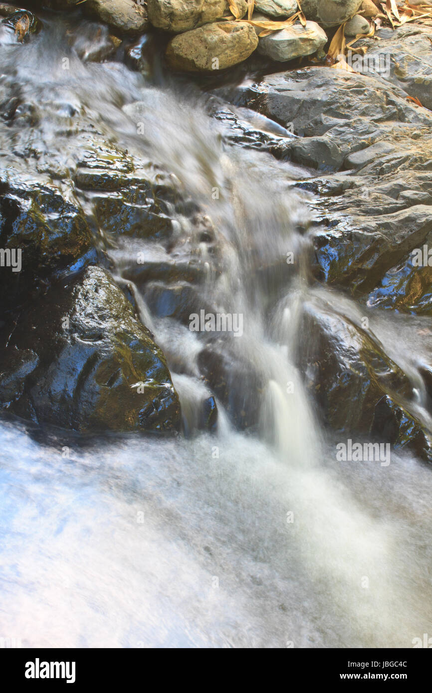 waterfall and rocks covered with moss in deep forest Stock Photo - Alamy