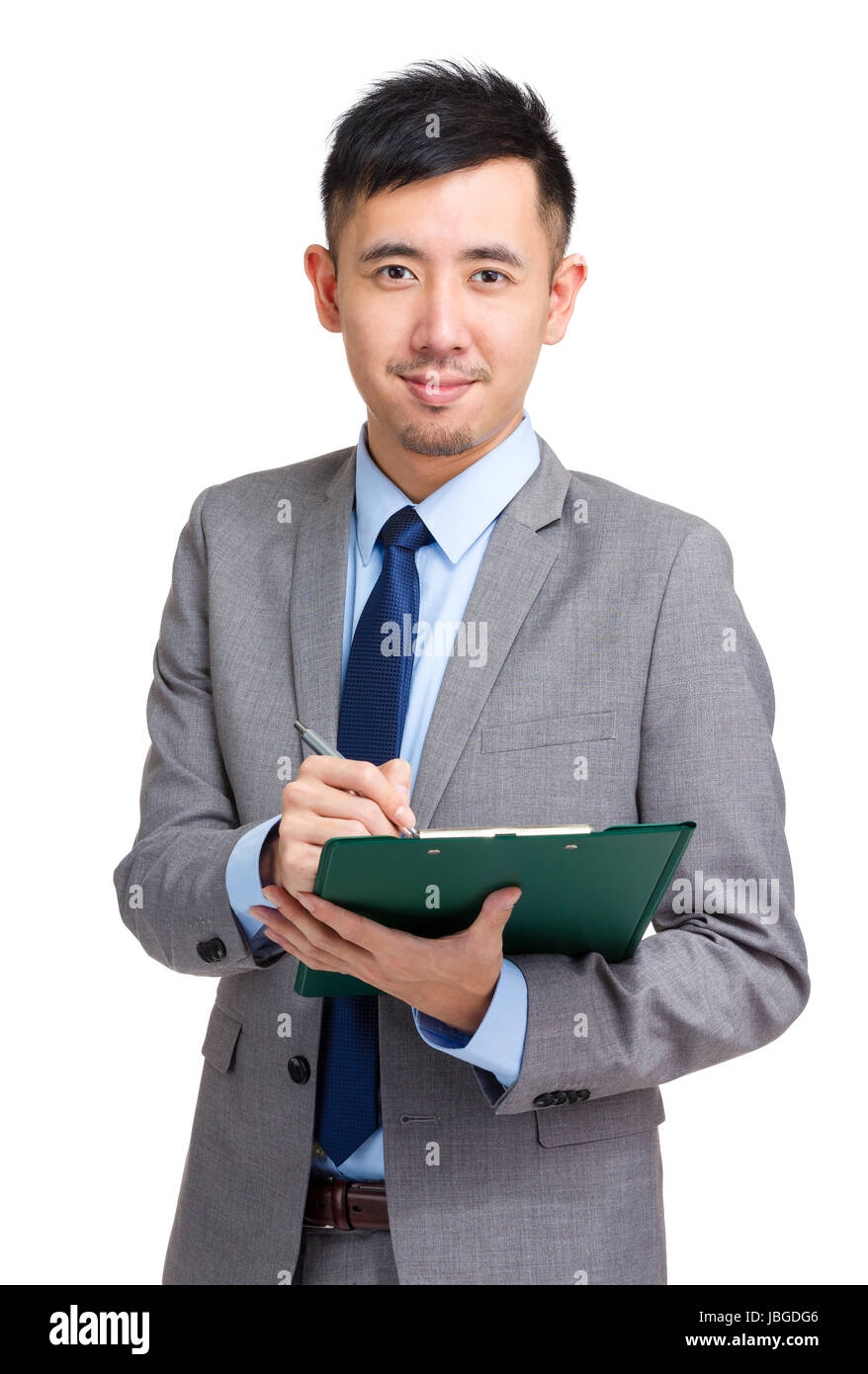 Businessman writing on clipboard Stock Photo - Alamy