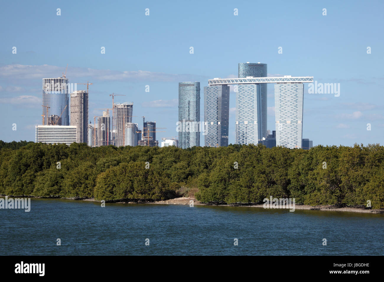 Skyline of Abu Dhabi Al Reem Island with mangrove forest in foreground Stock Photo