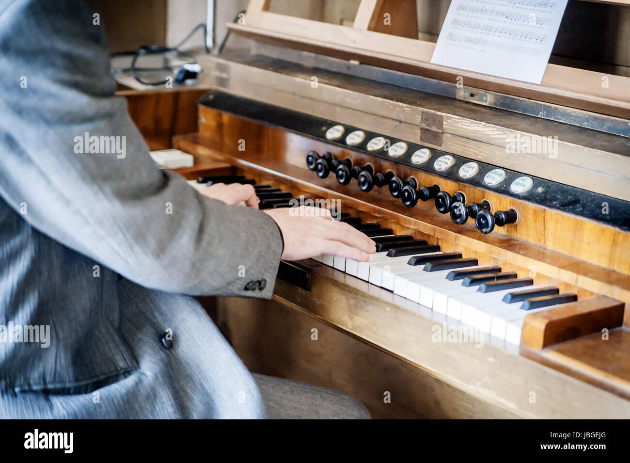 Man playing an old pipe organ in the church Stock Photo