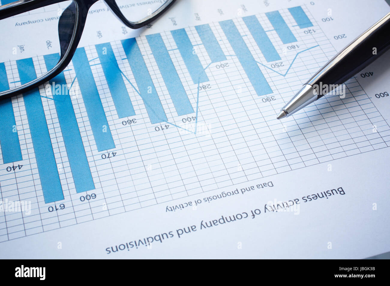 Image of eyeglasses, pen and financial document Stock Photo