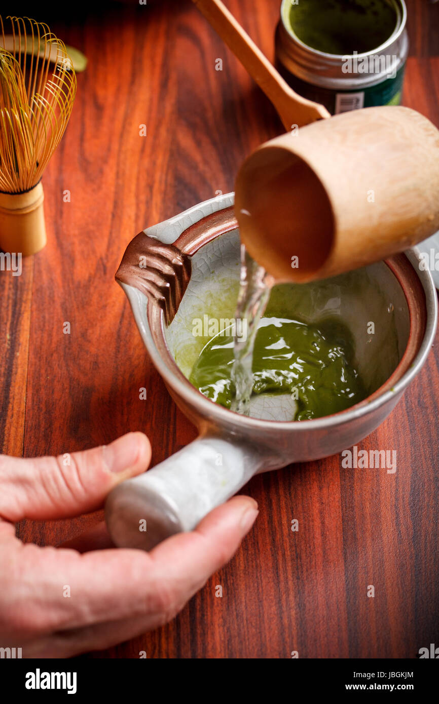 Tea master at tea ceremony, pouring water onto matcha tea Stock Photo