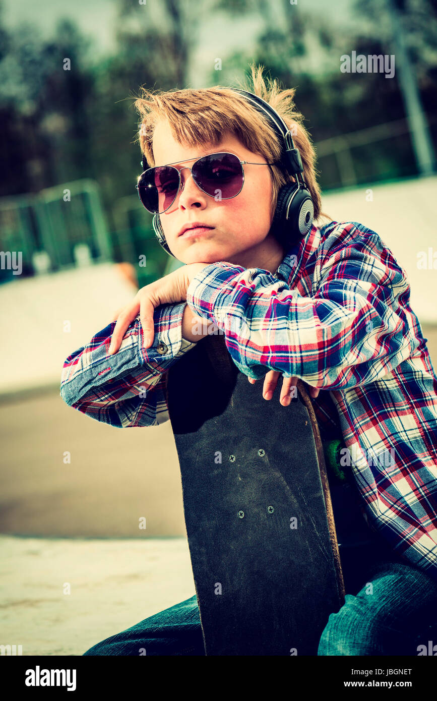 cool looking skater boy, with sunglasses and headphone vintage effect