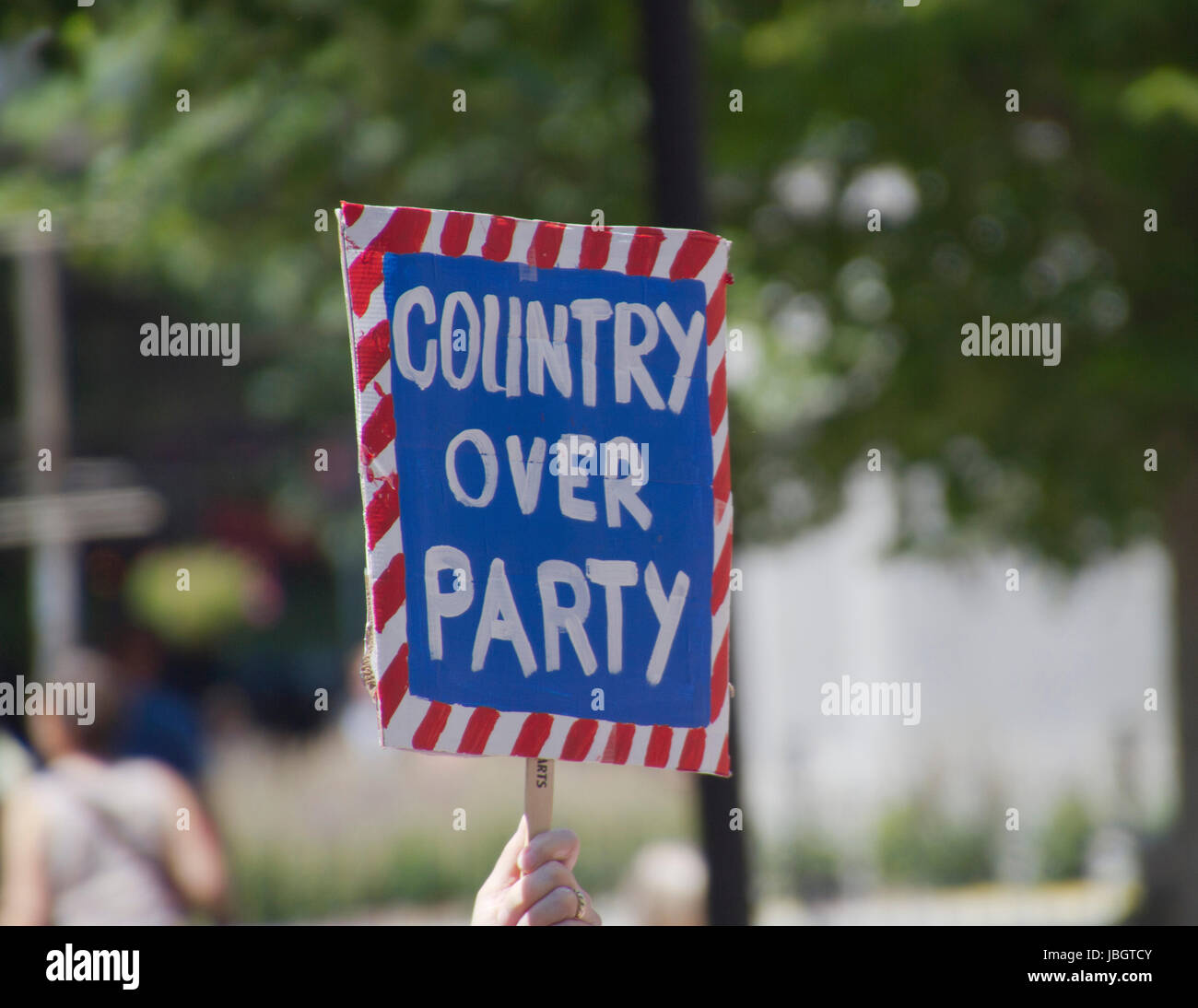 Asheville, North Carolina, USA - June 3, 2017: A patriotic 'March For Truth' sign says 'Country Over Party' protesting Donald Trump and the Republican Stock Photo
