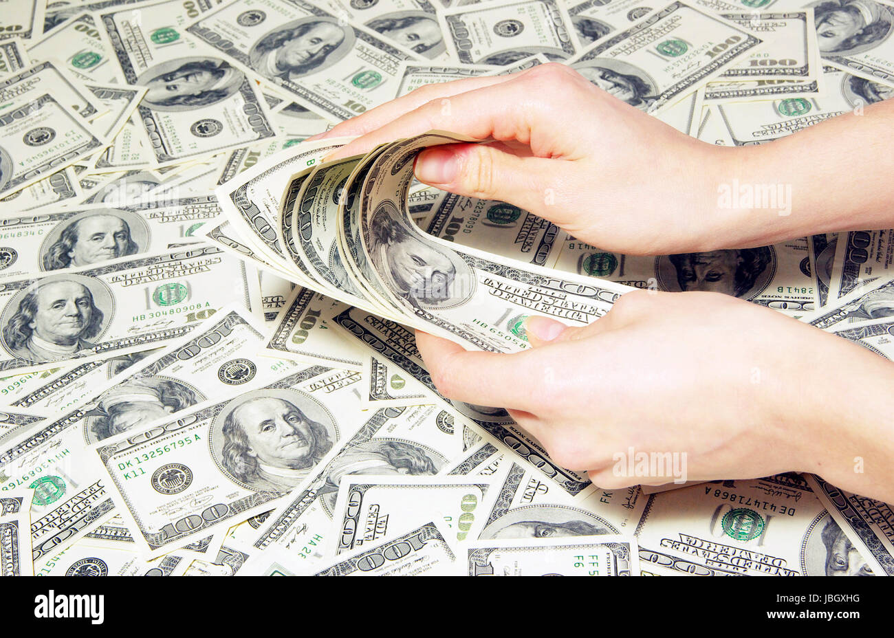 Hand with money isolated on money background Stock Photo - Alamy