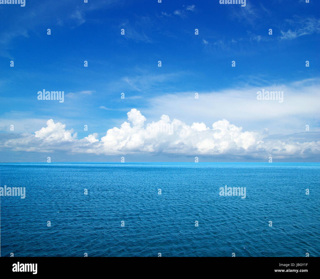cloudy blue sky above a surface of the sea Stock Photo - Alamy