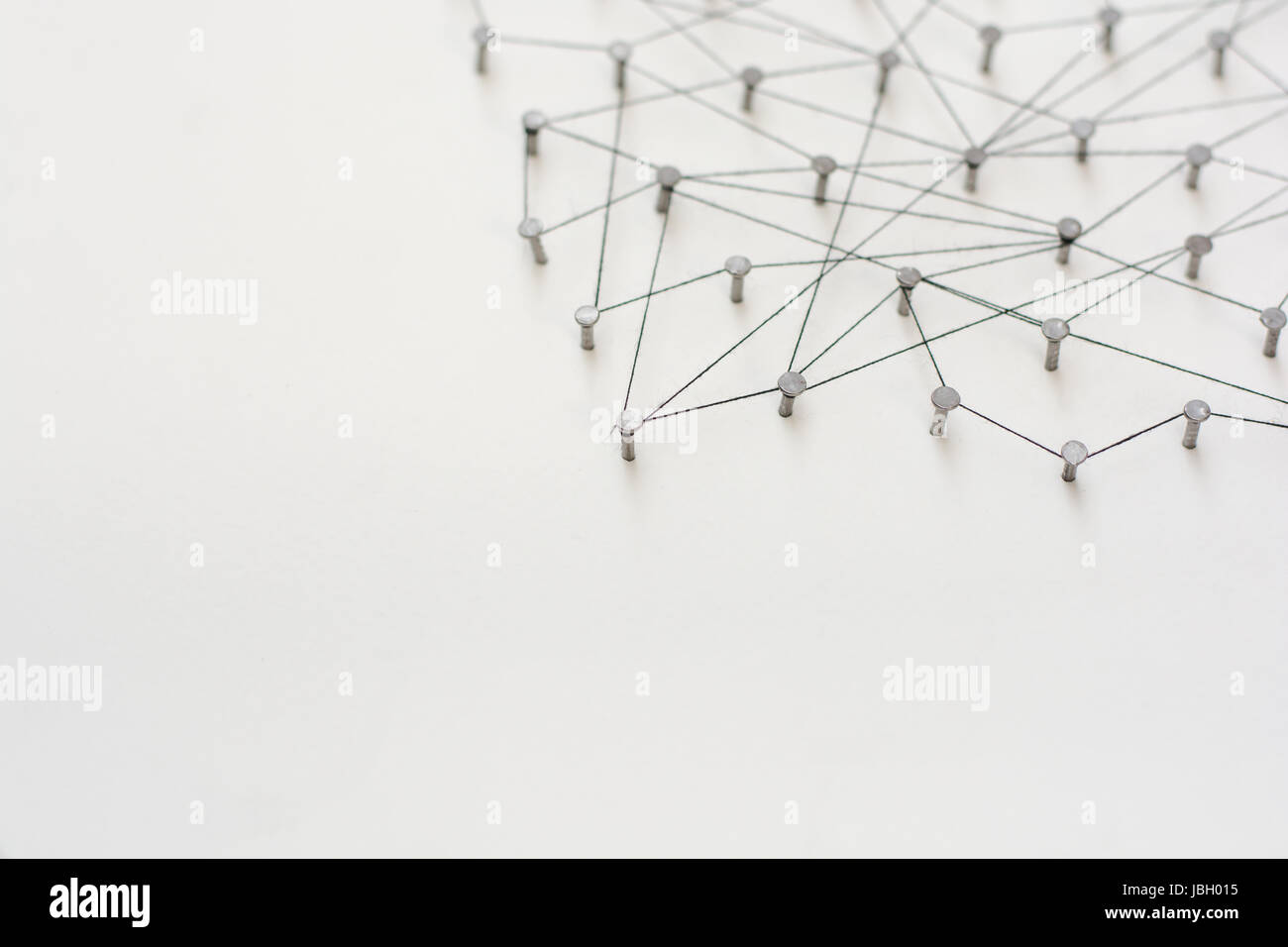 Linking entities. Network, networking, social media, internet communication abstract. A small network connected to a larger network. in paper linked t Stock Photo