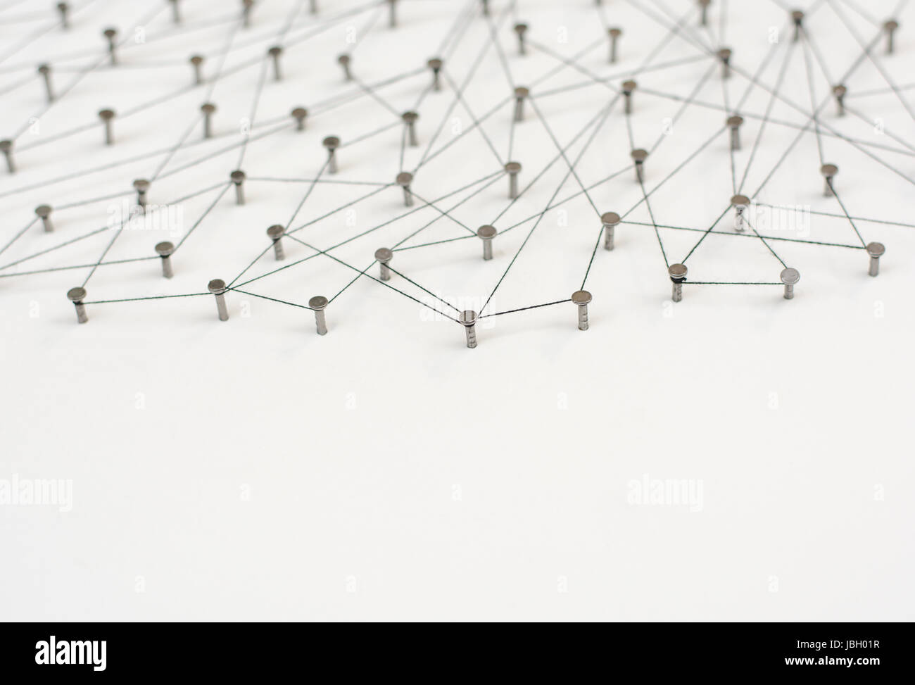 Linking entities. Network, networking, social media, internet communication abstract. A small network connected to a larger network. in paper linked t Stock Photo