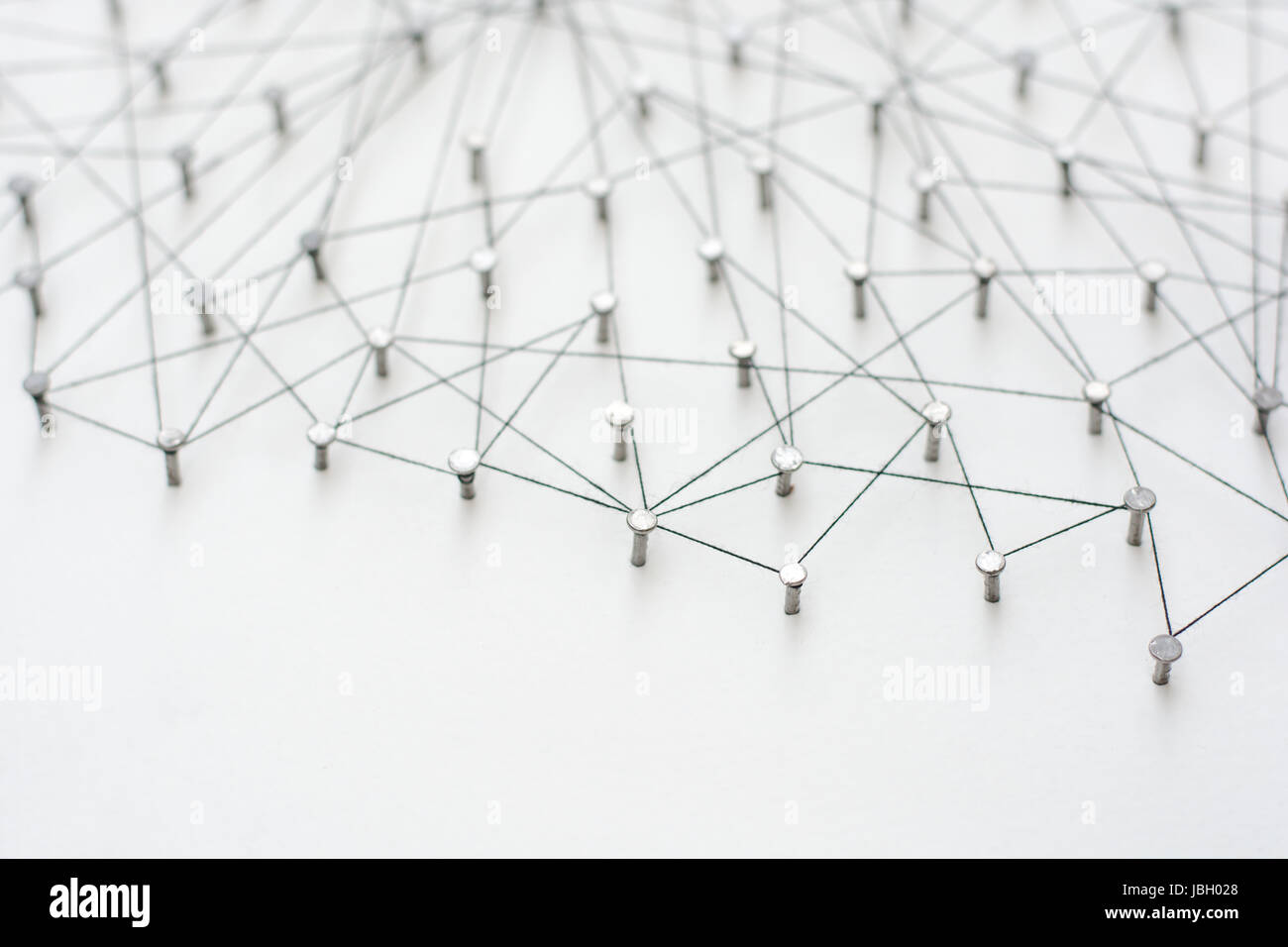 Linking entities. Network, networking, social media, internet communication abstract. A small network connected to a larger network. in paper linked t Stock Photo