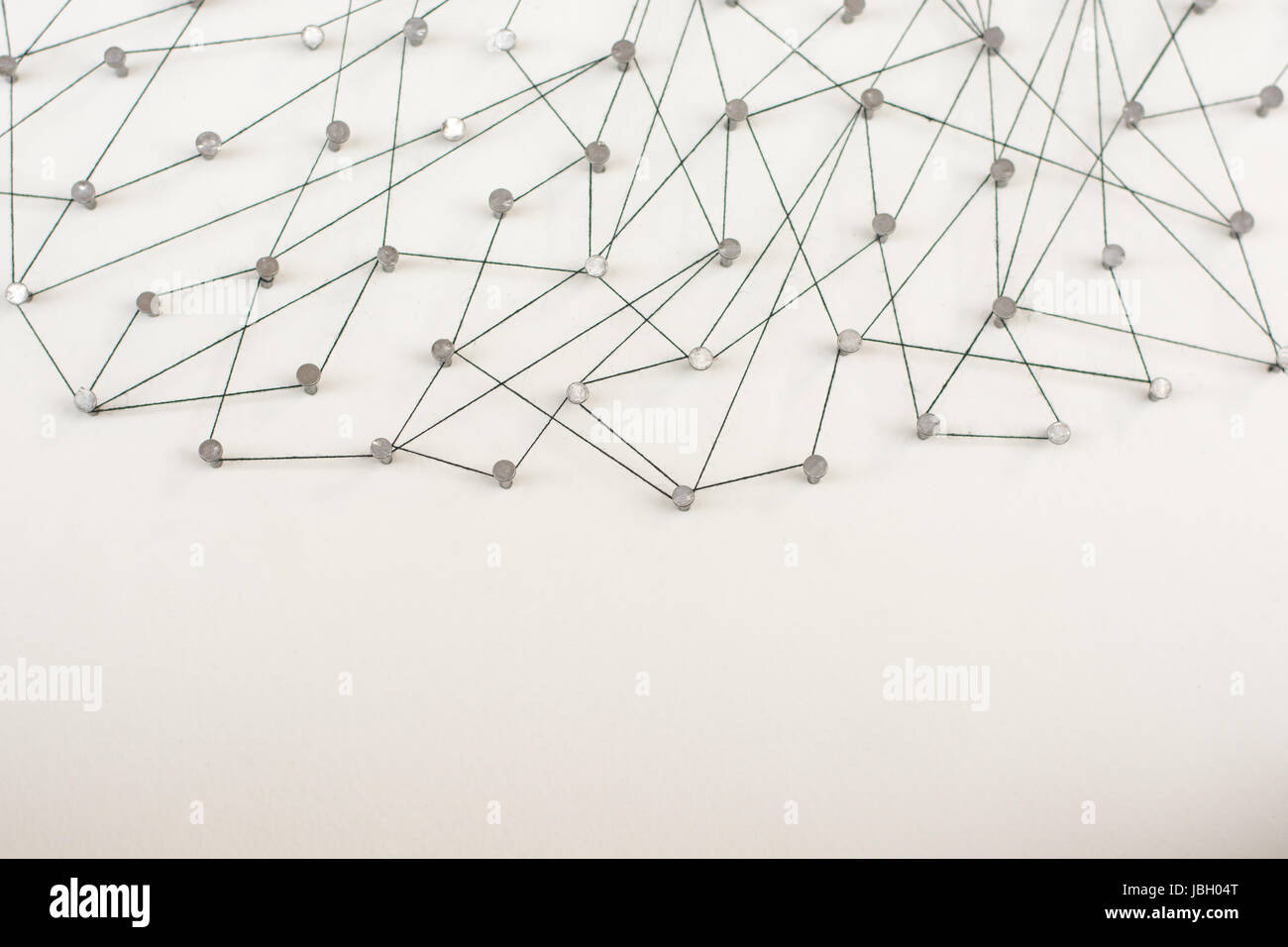 Linking entities. Network, networking, social media, internet communication abstract. A small network connected to a larger network. in paper linked t Stock Photo