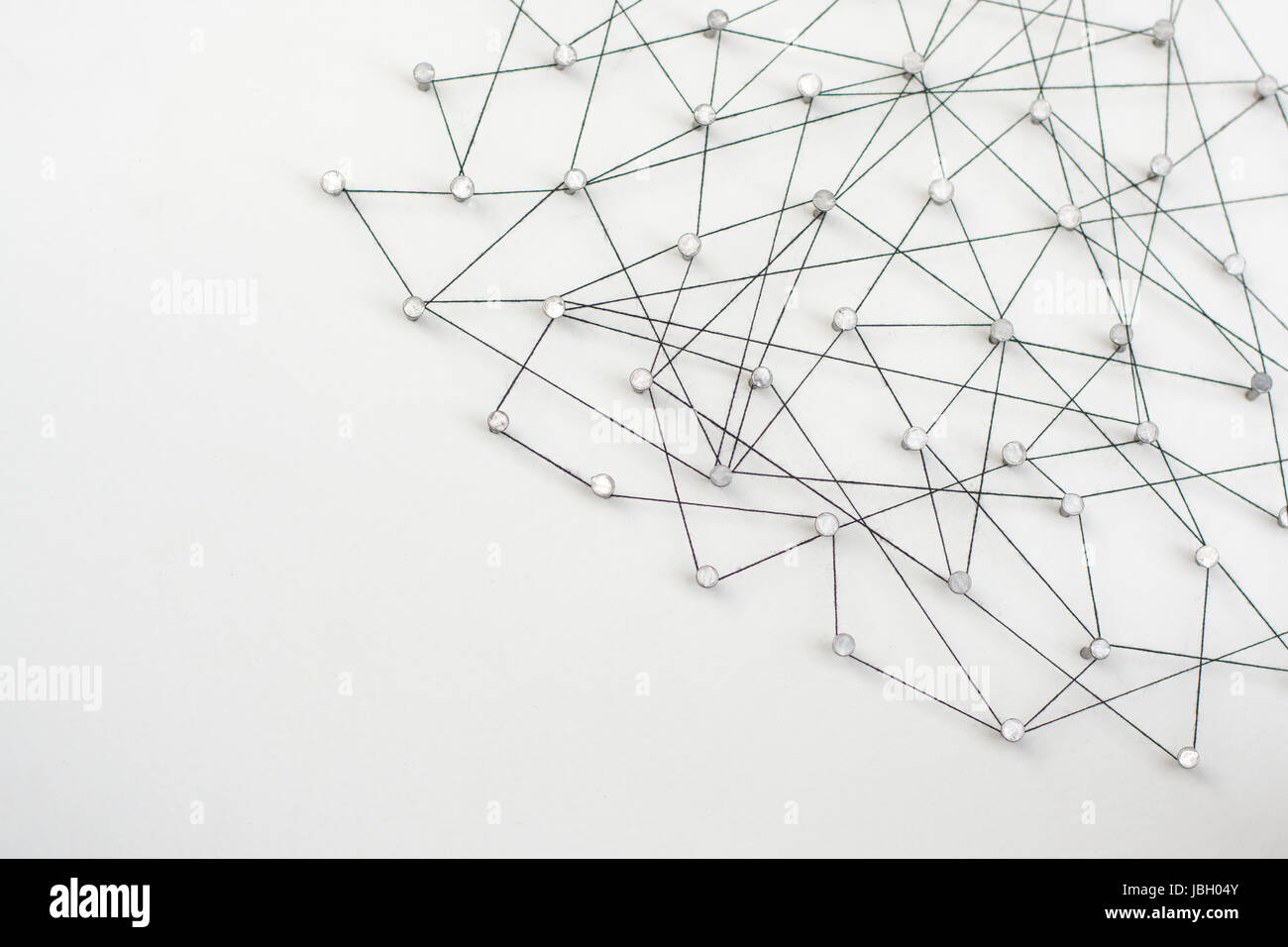 Linking entities. Network, networking, social media, internet communication abstract. A small network connected to a larger network. in paper linked t Stock Photo