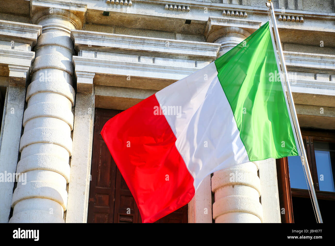 National flag flying against building in Venice, Italy. Its current form has been in use since 18 June 1946. Stock Photo