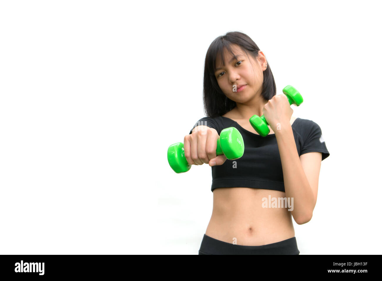 Attractive young fitness woman holding dumbbells isolated on white background. Stock Photo