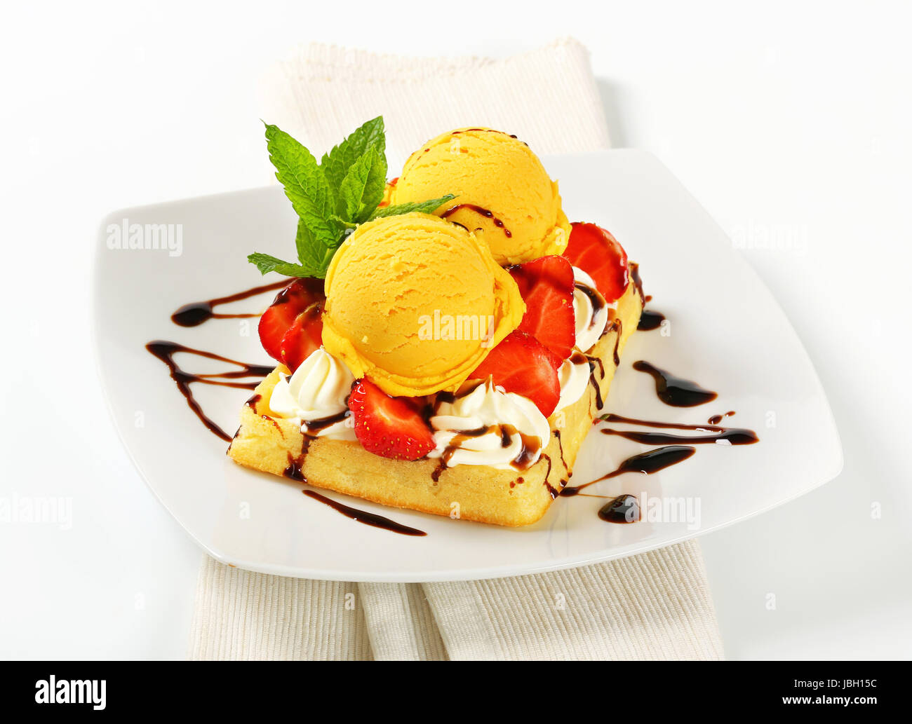 Belgian waffle topped with whipped cream, fresh strawberries and ice ...