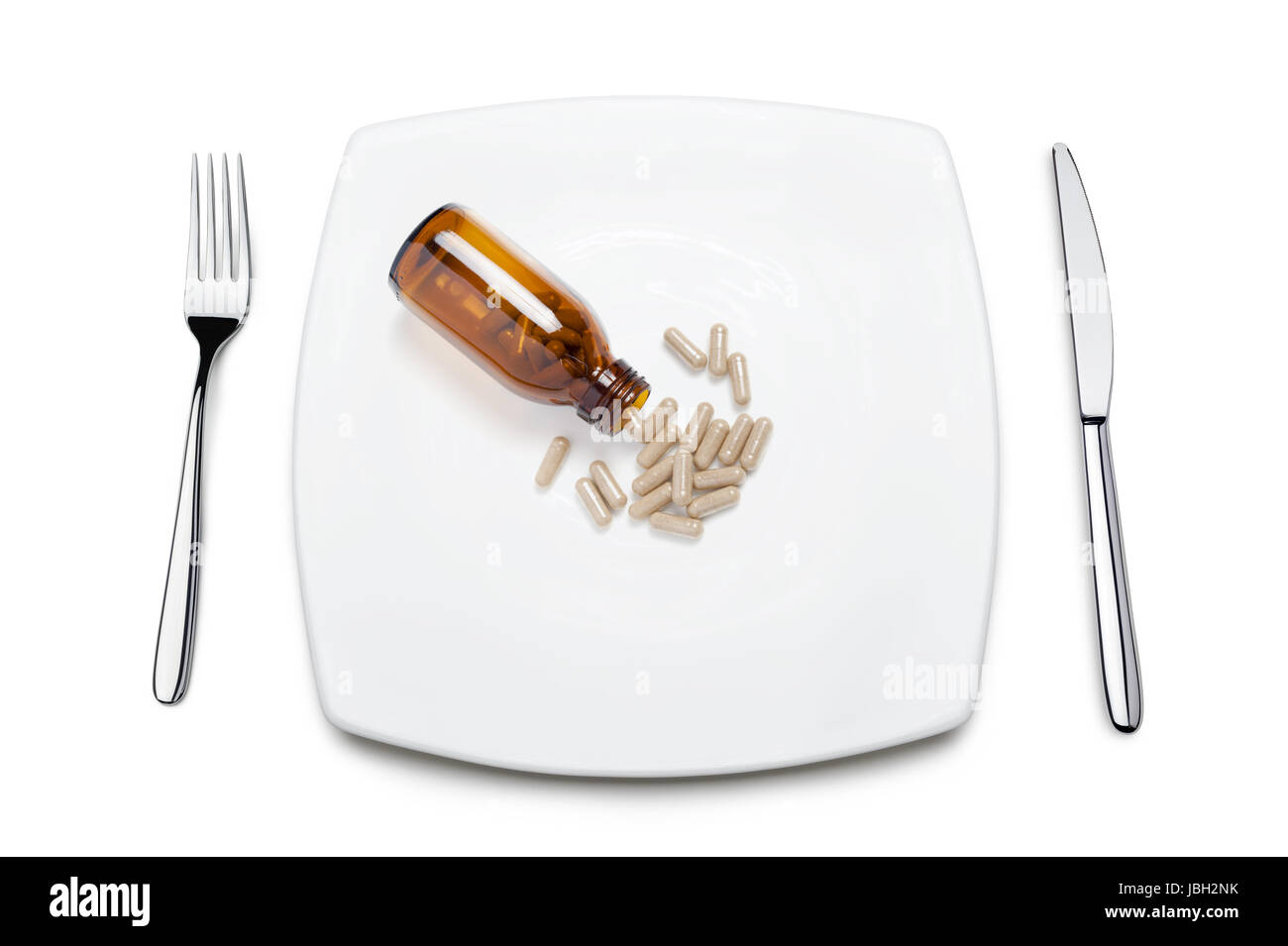 diet pills on plate, on white background Stock Photo - Alamy