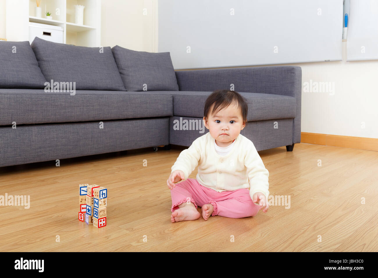 Asian baby girl play toy block at home Stock Photo - Alamy