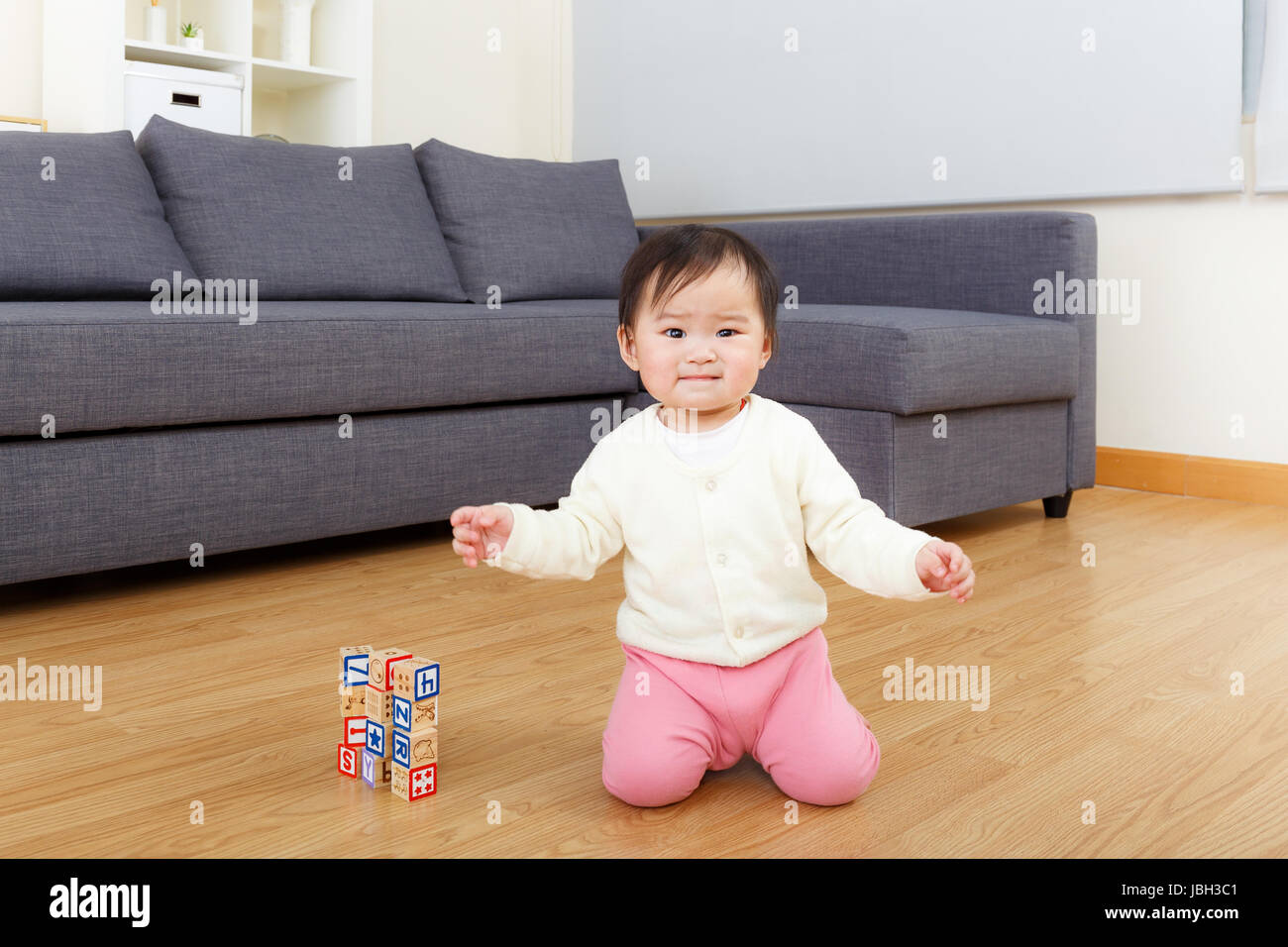 Asian baby girl play toy block at home Stock Photo - Alamy