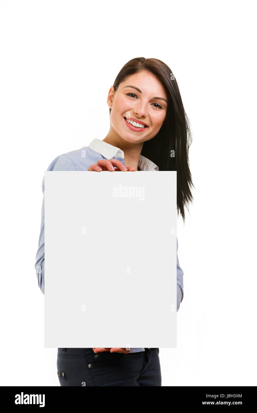 Happy smiling young woman showing blank signboard on white background ...