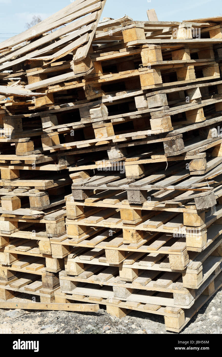 stack of empty wooden pallets in warehouse yard outdoors Stock Photo