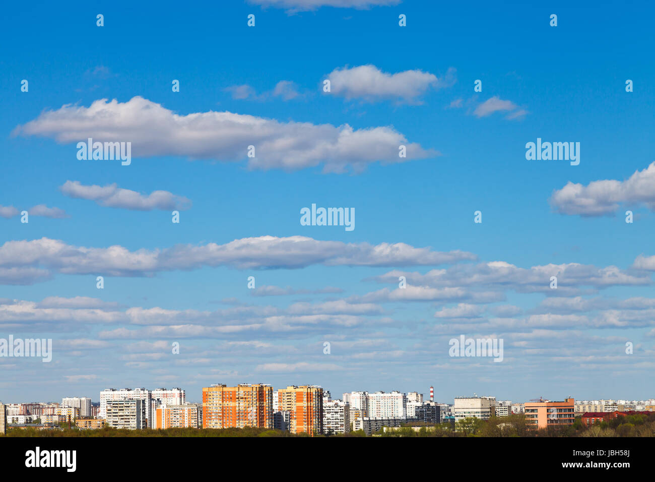 white clouds in blue sky over urban district in spring Stock Photo - Alamy